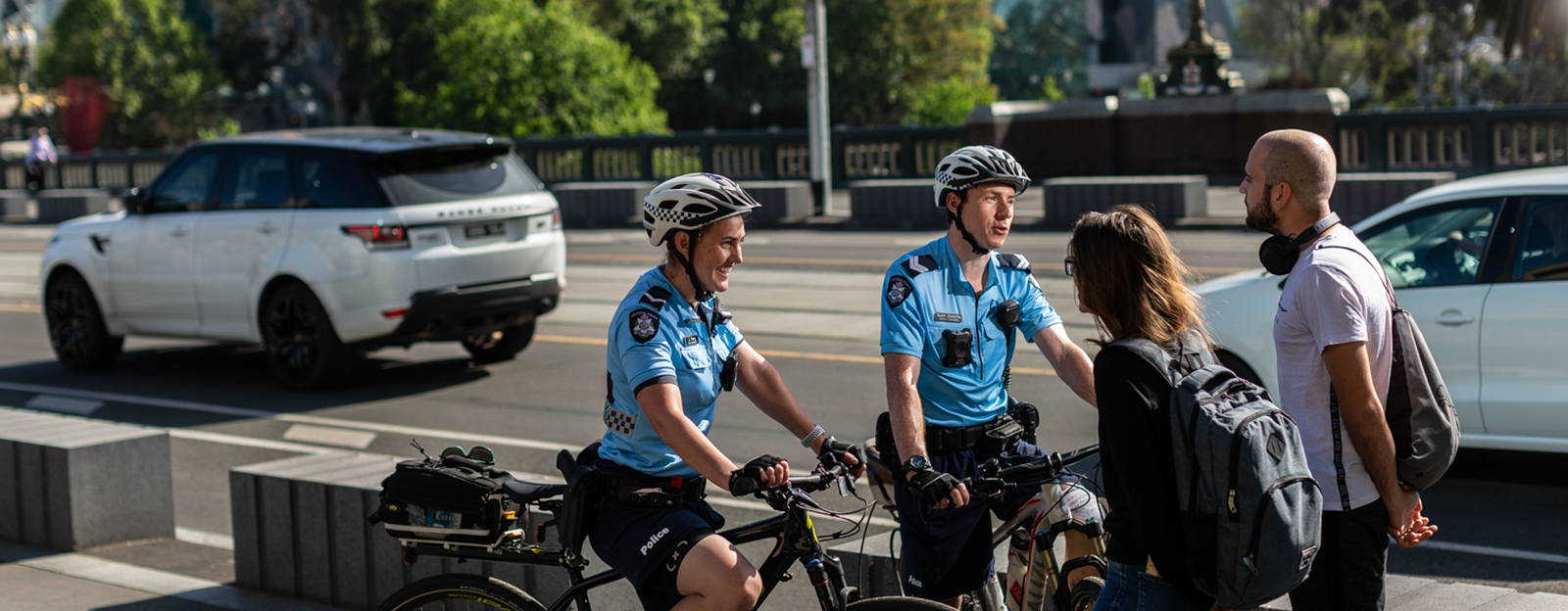 Bike patrol unit speak with pedestrians