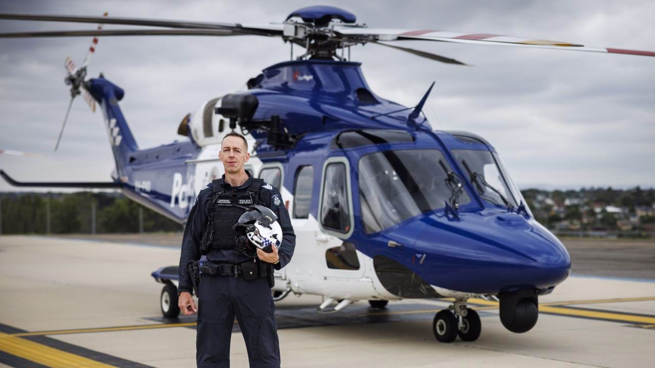 Police Life podcast - Hunting high and low - officer in front of a helicopter