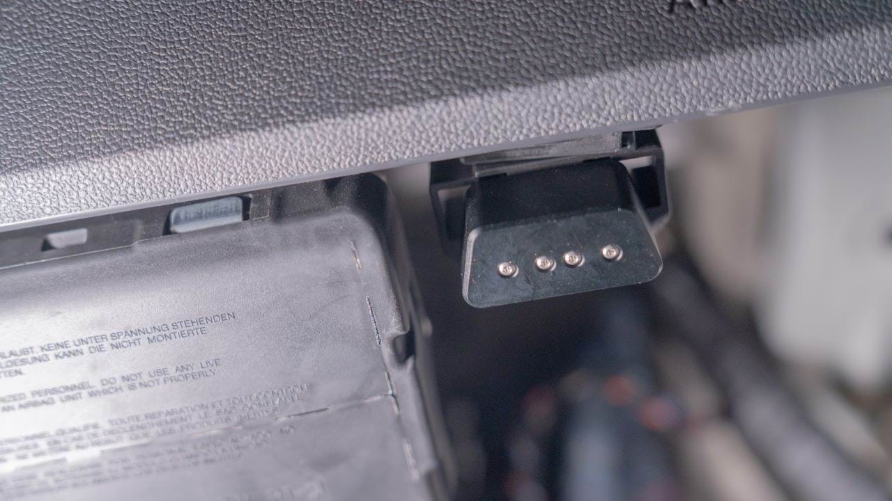Image of an OBD port lock secured to the OBD port.