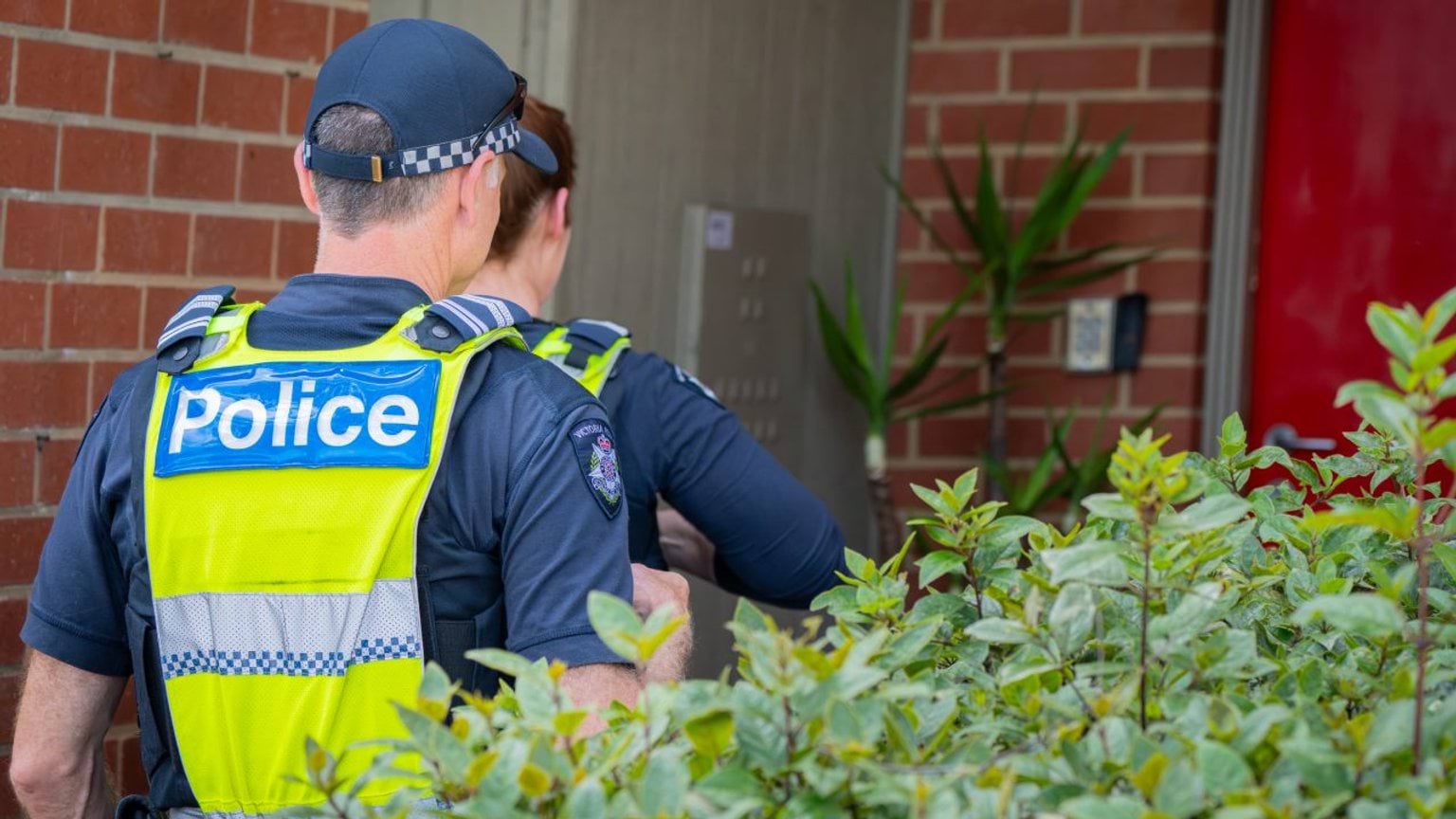 Homepage - Two officers outside a house door